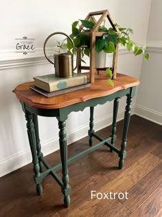 a table with books and a potted plant on it