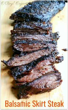 sliced steak sitting on top of a wooden cutting board with the words balsamic skirt steak