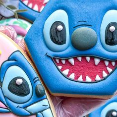 some cookies decorated to look like cartoon characters with teeth and fangs on their faces are shown