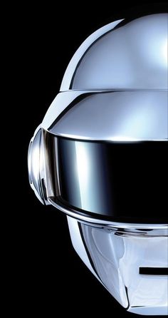 a close up of a helmet on a black background with the reflection of it's face