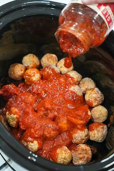 the sauce is being poured over the meatballs in the slow cooker to be cooked