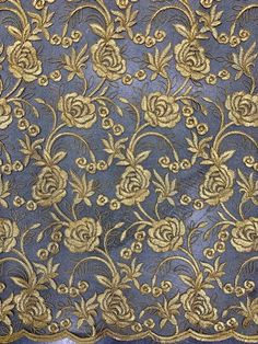 an old blue and gold cloth with flowers on it's edges, in the shape of roses