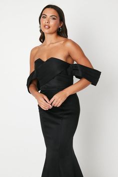 This beautiful bardot-style dress features a unique bow detail on the back, adding a charming and feminine touch to your look. Made with structured satin fabric, it offers a flattering fit and a luxurious feel. The cross-front design adds a modern twist, while the centre back zip ensures easy wear. With its fishtail hem, this dress is perfect for collage balls and black-tie weddings. Embrace sophistication and style with our dress that effortlessly combines classic and contemporary element.? Bardot Style, Petite Jumpsuit, Occasion Dresses Wedding, Petite Coat, Black Tie Wedding, Tall Clothing, Floral Outfit, Tshirt Skirt, Fit N Flare Dress