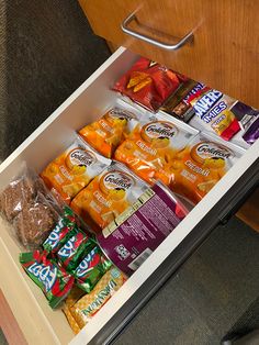 an open drawer filled with snacks and candy