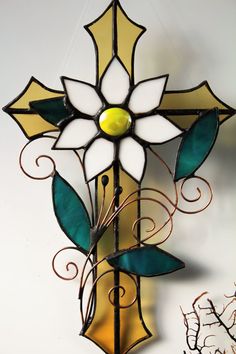 a stained glass cross hanging on the wall