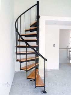 a spiral staircase in an empty room with white walls