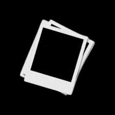 three white square coasters sitting on top of each other in front of a black background