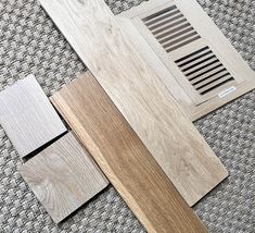 wood flooring samples laid out on top of each other, including one with a ventilator