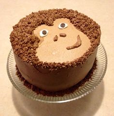 there is a cake that looks like a monkey face on the plate with eyes and nose