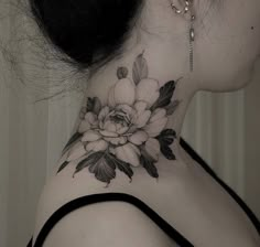 a woman with a flower tattoo on her neck