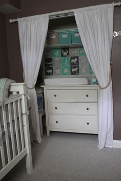 a baby's room with two cribs and a dresser in the corner