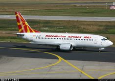 an airplane is on the runway with grass in the background and yellow lines painted on the tarmac