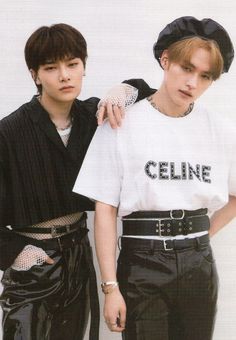 two young men standing next to each other wearing black pants and white shirts with the word cline on them