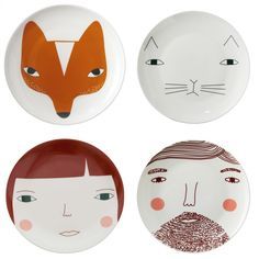 three plates with different designs on them, one has a face and the other has a fox