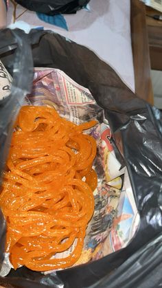 a plastic bag filled with orange rings on top of a table