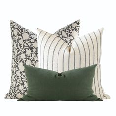 three pillows with green and white stripes on them