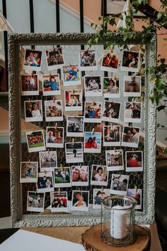 a photo frame with pictures on it sitting next to a candle and potted plant