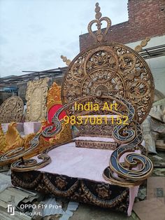 an intricately designed bed in the middle of a pile of junk