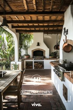 an outdoor kitchen with a table and chairs