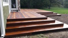 a wooden deck with steps leading up to the door