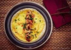 an omelet on a plate with garnishes and napkins next to it