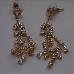 Approx. 2″ Length, 0.5 Width Cubic Zirconia Chandelier Drop Earrings. 18k Gold Plated. Gold Plated Chandelier Dangle Earrings For Parties, Gold Plated Dangle Chandelier Earrings For Party, Gold Plated Chandelier Earrings For Party, Elegant Gold Plated Jewelry With Dangling Charms, Wedding Chandelier Earrings, Gold Plated, Elegant Silver Chandelier Earrings With Dangling Charms, Teardrop Cubic Zirconia Chandelier Earrings, Elegant Party Jewelry With Dangling Charms, Cubic Zirconia Chandelier Drop Earrings