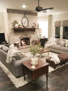 a living room filled with furniture and a fire place in the middle of the room