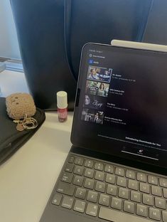 an open laptop computer sitting on top of a desk next to a cell phone and wallet