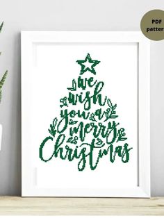 a cross stitch christmas tree on a shelf