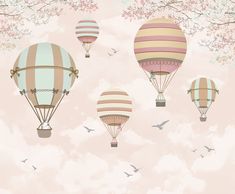 several hot air balloons flying in the sky with cherry blossom trees and birds around them