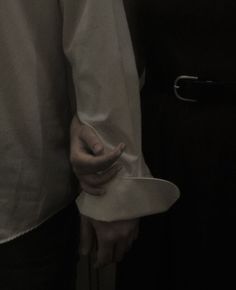 two people standing next to each other holding hands