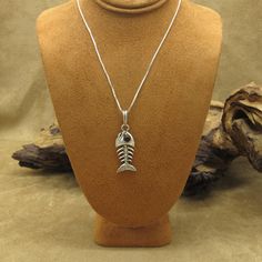 Sterling silver fish bones pendant necklace. The fish is 1 1/2" tall including the bail. It is 1/2" wide. There is an amber colored eye. 925 is stamped on the tail.  The pictured silver box chain is 18" long and is included. Thank you for shopping in our store. Please let us know if you have questions. MS-8 k Fish Skeleton, Fish Bones, Eye Pendant Necklace, Silver Fish, Eye Pendant, Silver Box, Fish Bone, Amber Color, The Fish