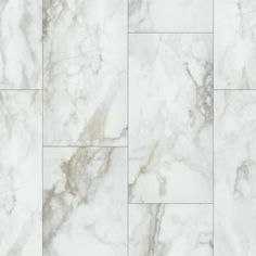 a white marble tile wall with different patterns