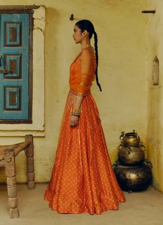 The rust printed, hand-embroidered lehenga in dupion silk paired with a printed corset blouse and an embroidered net dupatta sounds like a stunning ensemble. The combination of the printed corset blouse and the hand-embroidered lehenga adds depth and richness to the outfit, while the embroidered net dupatta enhances its elegance. Unstitched Orange Silk Lehenga, Silk Lehenga With Resham Embroidery In Orange, Designer Orange Silk Lehenga, Orange Silk Lehenga With Resham Embroidery, Orange Silk Lehenga For Designer Wear, Designer Wear Orange Silk Lehenga, Orange Anarkali Lehenga In Organza, Anarkali Orange Organza Lehenga, Semi-stitched Silk Orange Lehenga