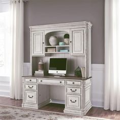 a white desk with a computer on top of it