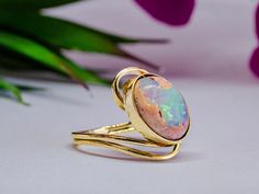 ✨ Empowerment in Gold: Handmade Cantera Opal Gold Ring ✨ Elevate your style with the captivating beauty of our Handcrafted Cantera Opal Gold Ring, a luxurious piece of Mexican artisan jewelry. Designed with a 14k gold cathedral-inspired setting, this ring showcases a stunning 12mm x 10mm Cantera Matrix Opal, known for its vibrant play of colors. Perfect for October birthdays, anniversaries, or any special occasion, this ring exudes sophistication and elegance. 💍✨ 🌟 Key Features: Genuine Canter Luxury Artisan Opal Ring For Gift, Handmade Elegant Yellow Gold Opal Ring, Handmade Round Opal Ring For Formal Events, Handmade 14k Gold Elegant Opal Ring, Handmade Elegant 14k Gold Opal Ring, Handmade Elegant Opal Ring In 14k Gold, Handmade Opal Ring For Formal Occasions, Handmade 14k Gold Opal Ring, Handmade Opal Ring For Formal Events