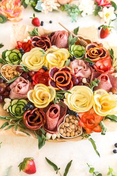 a platter filled with lots of different types of food on top of a table