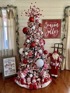 a red and white christmas tree decorated with ornaments