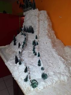 a snow covered mountain with trees on it and a castle in the top right corner