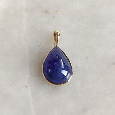 This stunning Pendant is set in 14k Solid Yellow Gold with Natural Tanzanite with utmost precision. It is a unique gemstone Pendant for nearly every occasion and is completely hassle-free jewelry. ITEM DETAILS: * CENTER GEM: Tanzanite * GEM SIZE: 13X18mm * GEM SHAPE: Pear * Gem WEIGHT: 14.55 carats * Gold Purity: 14KT * Gold Weight: 0.65 gram * Total Weight: 3.56 gram The Gold purity is guaranteed and it comes with authentic 14KT gold hallmark. Since my items are handmade, they are absolutely nickel and lead free. CUSTOMIZATION: * Gemstone customization is available and it can be substituted with a gem of your choice. Kindly message me for the same. PACKAGING * The Pendant comes with layers of safe and secure wrapping along with Free handmade jewelry box with every purchase. ➡️Head to thes Yellow Gold Teardrop Gemstones For Anniversary, Anniversary Yellow Gold Teardrop Gemstones, Luxury Tanzanite Pear-shaped Jewelry, Gold Teardrop Gemstones For Formal Occasions, Gold Teardrop Gemstones For Formal Events, Luxury Pear-shaped Tanzanite Jewelry, Formal Gold Teardrop Gemstones, Teardrop Yellow Gold Jewelry With High Luster, Anniversary Yellow Gold Tanzanite Jewelry