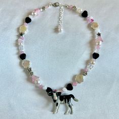 Enter the charming realm of pink elegance with our "The Milky Way" handmade beaded necklace, adorned with an adorable cow charm. Delicately crafted with a girly touch, each bead radiates soft hues of pink, exuding an aura of sweet sophistication. The darling cow charm adds a playful accent, infusing the piece with whimsical charm. Perfect for those who adore girly accessories with a hint of countryside flair, this necklace is a delightful addition to any ensemble. Whether you're dressing up for Throwing Fits, Bracelet Inspo, Handmade Beaded Necklaces, The Milky Way, Aesthetic Ideas, Girly Accessories, Bead Shop, Beaded Necklaces, Jewelry Inspo