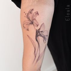 a woman with a tattoo on her arm has a flower tattooed on her left arm