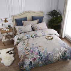 a bedroom with a bed covered in a floral comforter and matching pillowcases