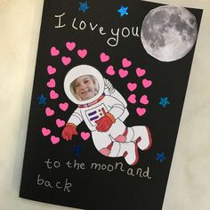 a card with an astronaut on it and the words i love you to the moon and back