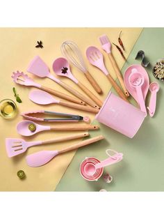 pink kitchen utensils and measuring spoons laid out on a table