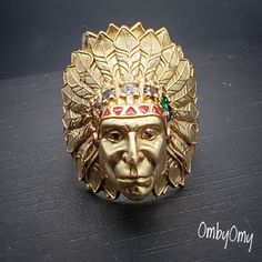 Super detailed Indian Chief Head ring, carefully detailed American Indian face. Total Carat Weight . 15.7 Dtw or 24.4 grams Main Stone Creation: Lab-Created Country/Region of Manufacture: United States Collectible Luxury Gold Rings, 14k Gold Multi-stone Ring, Traditional Yellow Gold Rings Stamped 14k, Traditional 14k Stamped Yellow Gold Rings, Traditional 14k Yellow Gold Rings, Traditional 14k Gold Ceremonial Rings, Unique Collectible Gold Rings, Collectible Gold Rings With Gemstones, Unique Gold Collectible Ring