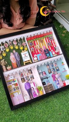 a woman sitting in front of a display case filled with pictures and cards on the grass