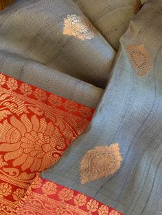 A stunning combination of light gray and red in this pure silk tussar benarasi saree. This combination is very unique and special, and is hard to find. The body is a steel gray with contrast rich red pallu and border, and golden zari benarasi weaving. The fabric is pure silk tussar (Silk Mark Certified) and is very luxurious and sturdy. Saree has a beautiful glow reflecting from the golden zari as well as from the tussar yarns. This saree has been woven in a handloom by weavers in Varanasi, Indi Gray Traditional Wear For Festive Occasions, Gray Festive Traditional Wear, Festive Gray Traditional Wear, Gray Traditional Wear For Diwali, Gray Traditional Wear With Pallu, Traditional Gray Wear With Pallu, Traditional Gray Dupatta With Traditional Drape, Traditional Gray Dupatta For Festive Occasions, Traditional Gray Dupatta