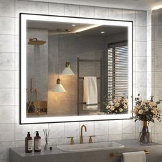 a bathroom with a sink, mirror and flowers in the vase on the counter top