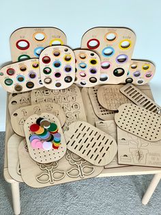 an assortment of wooden toys sitting on top of a table next to each other with holes in them